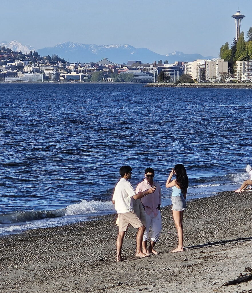 The Space Needle and snow capped Cascades visible from Alki Beach