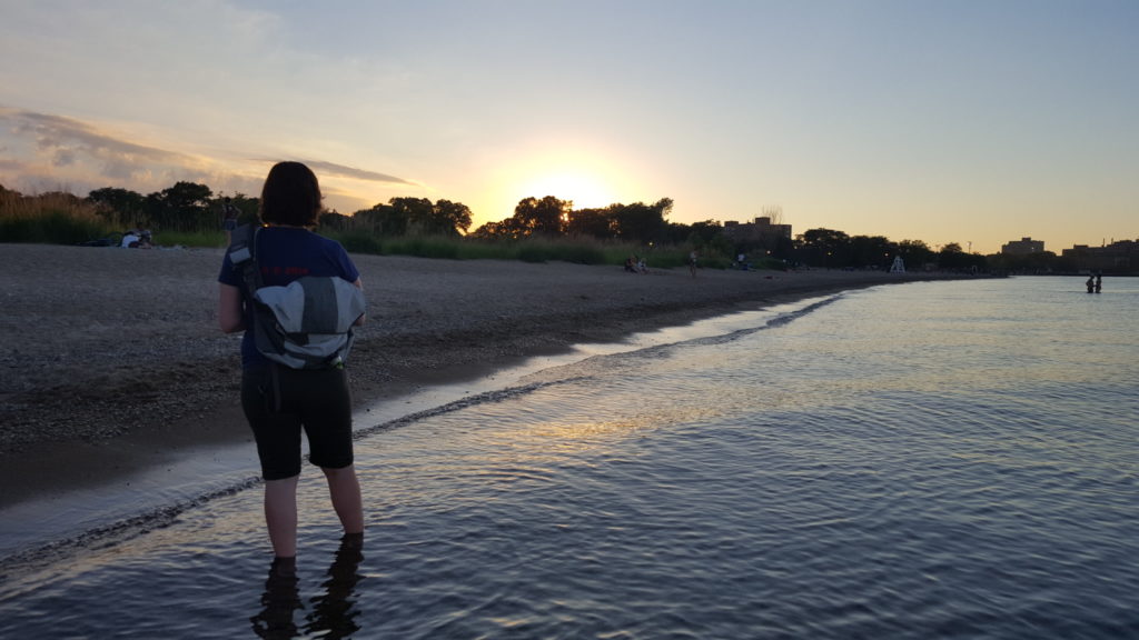 Perfect flat water, and warm water temperatures in Lake Michigan, at sunset at Loyola Beach.
